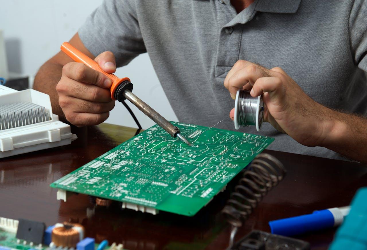 Technician soldering an electronic circuit board