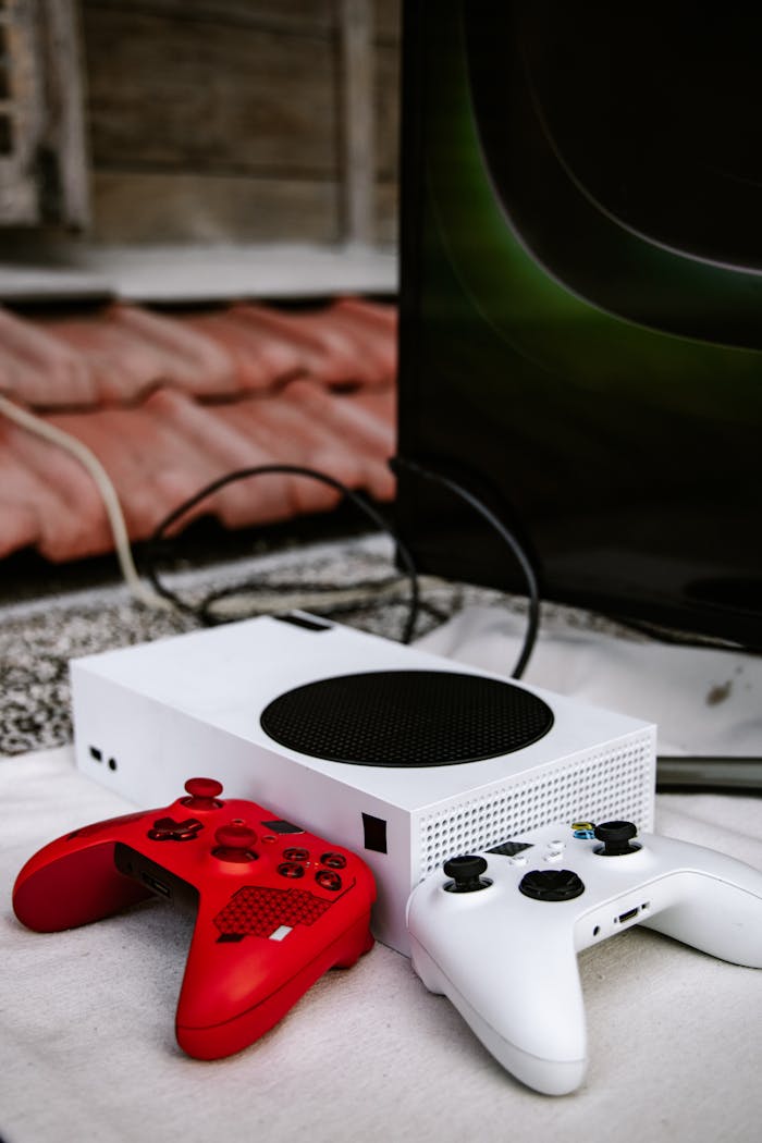 Xbox game console setup with vibrant red and white controllers, emphasizing wireless gaming.